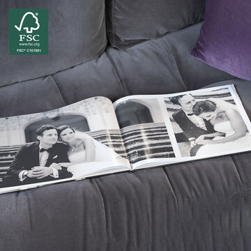 An open photo book shows beautiful wedding photos of a smiling couple. The background is elegant and romantic.