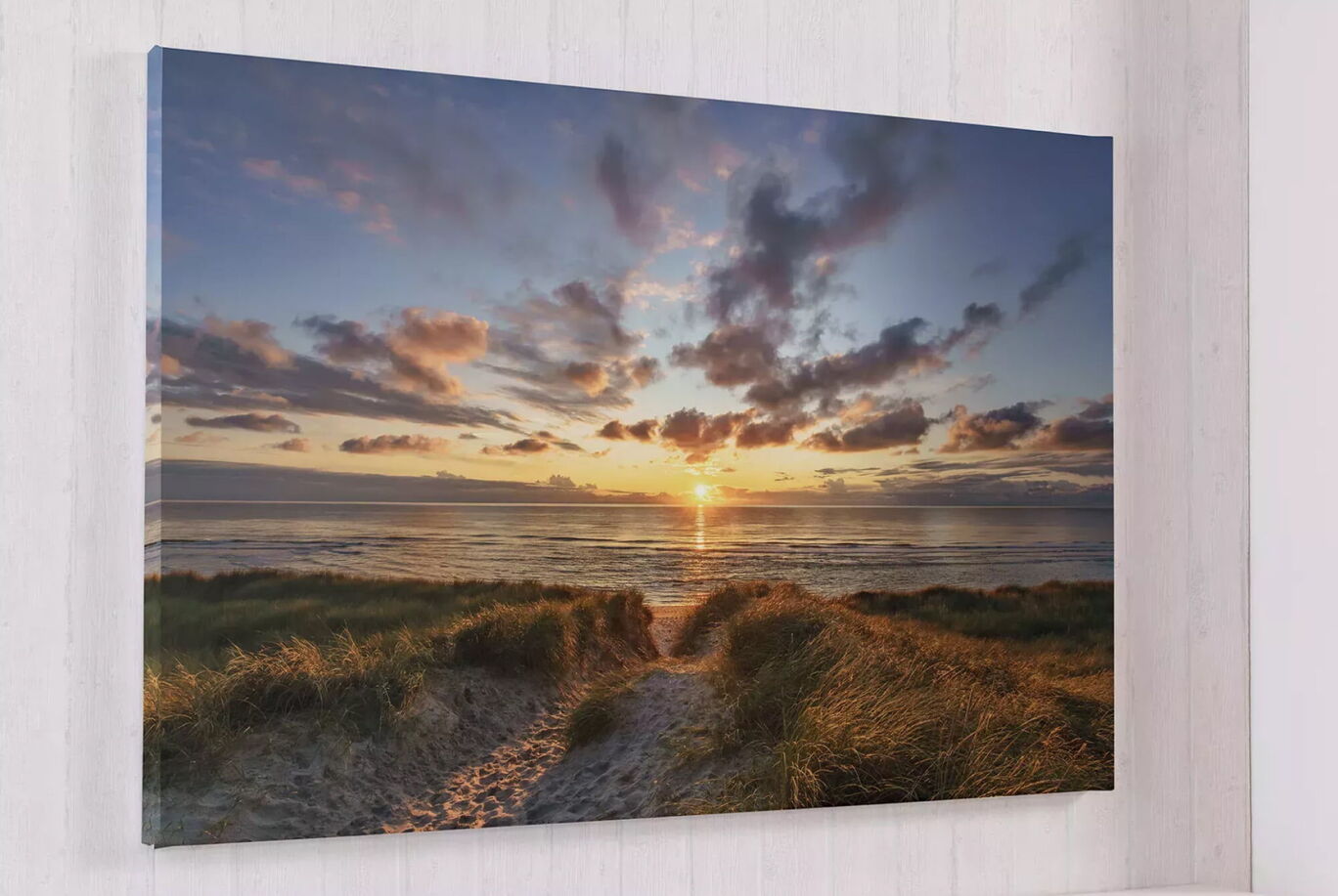 Beautiful sunset over the sea with the sky glowing in orange and blue.