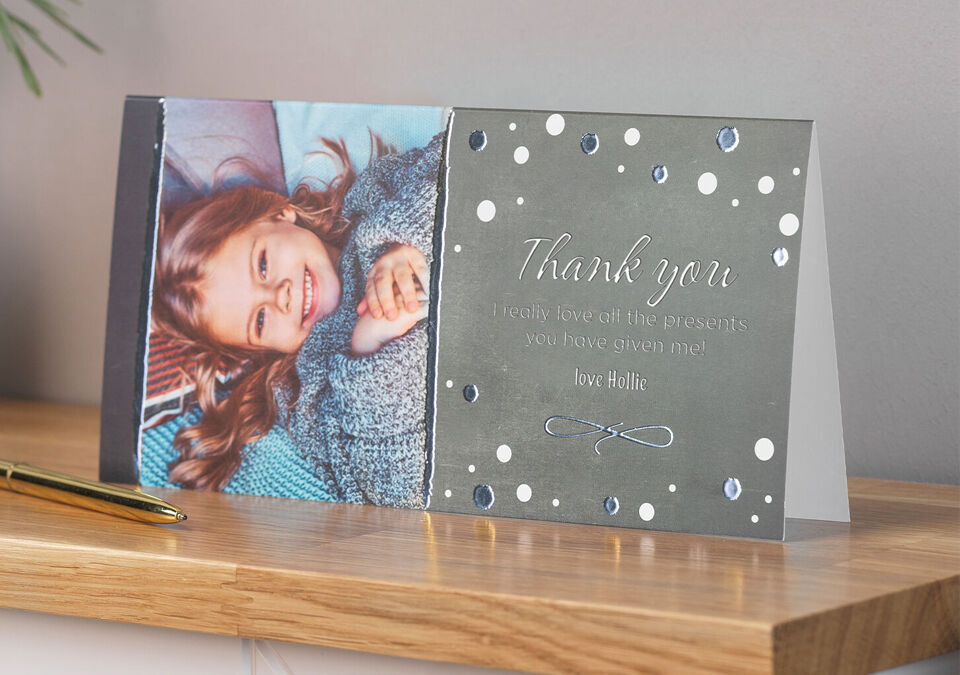 Smiling boy in a cozy sweater on a thank you card front