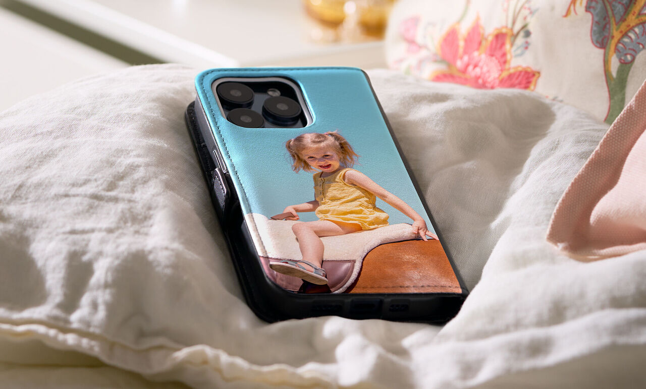 Bright smartphone case showing a cheerful child in a yellow dress.