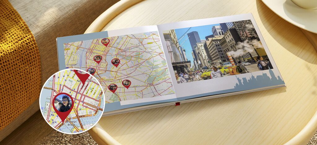 The image shows an open photo book with a map and travel moments on a tabletop.