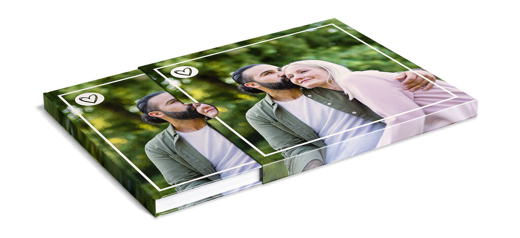 Two CEWE photo books with romantic photos, against a green background.