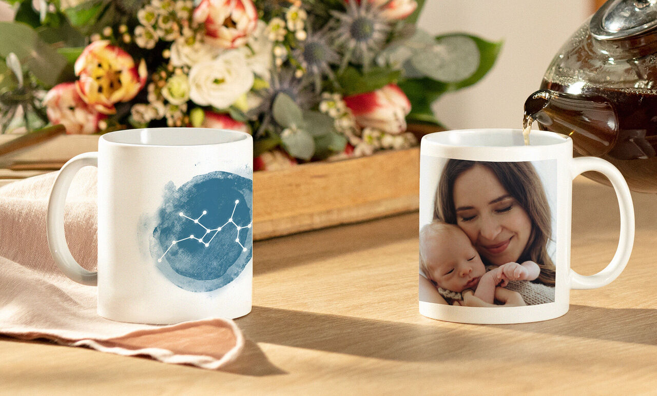 People enjoying a mug with a unique design surrounded by flowers.