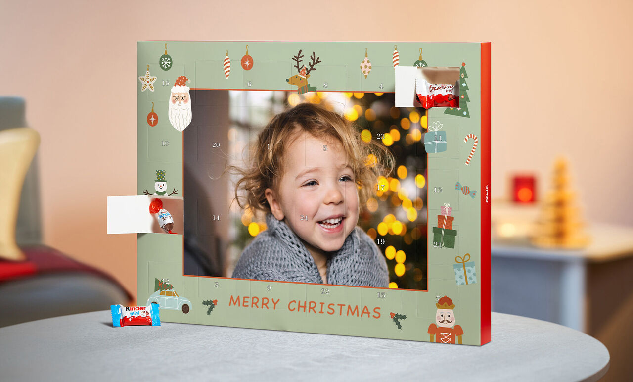 A beautiful advent calendar with Christmas motifs and lights in the background.