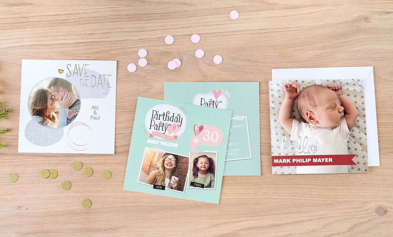 Three creative CEWE greeting cards on a wooden table with confetti and coins.