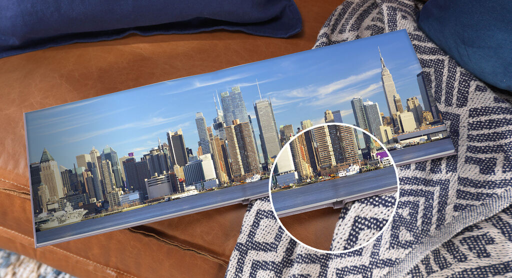 A CEWE photo book on a table showing a city view of New York.