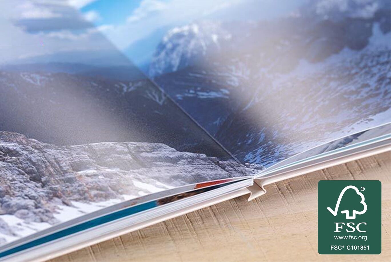 Close-up of an open photo book featuring stunning landscape photos.