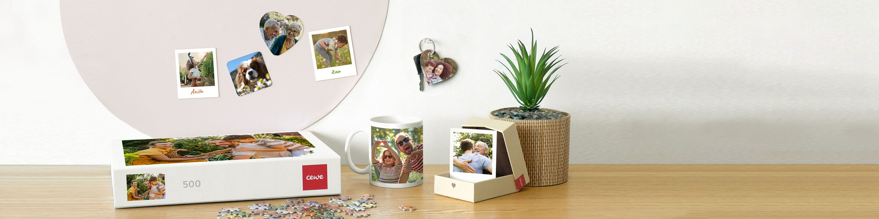 Various personalized photo products on a table including a photo book, mug, and photo decor.