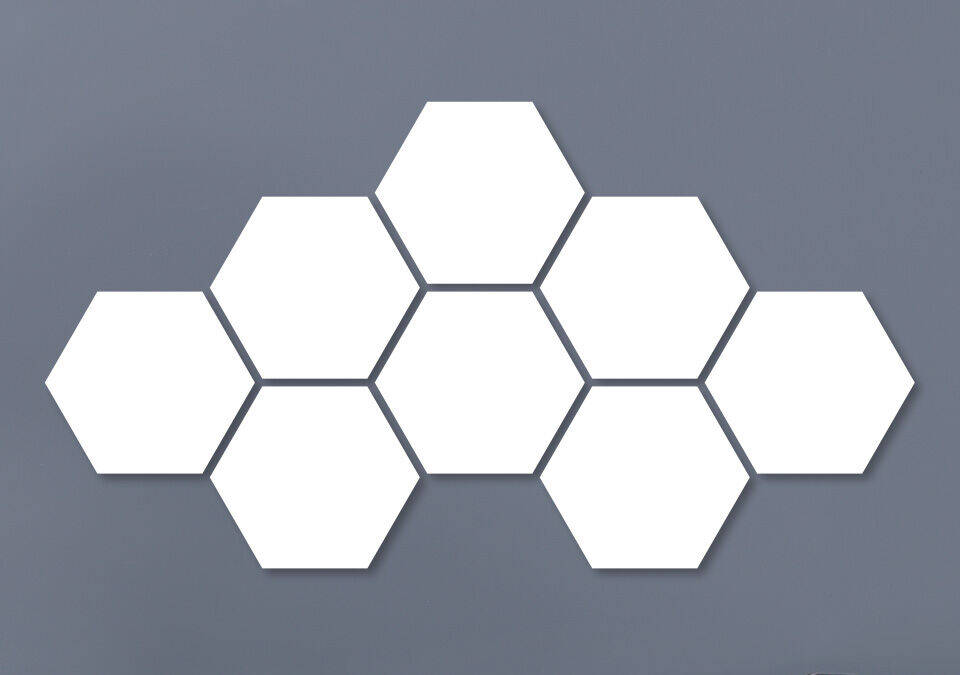 White hexagonal wall decoration on a gray background.