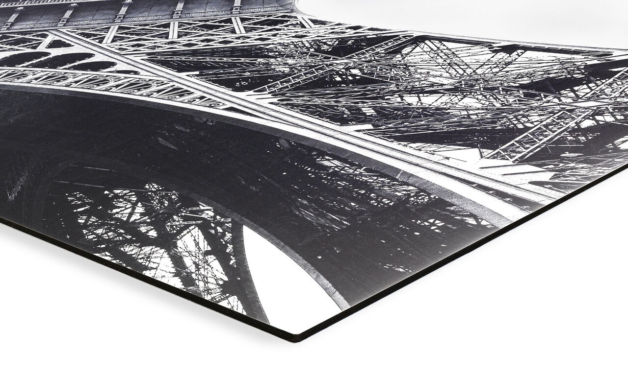 The detail view of the artfully designed frame of the Eiffel Tower in black and white.