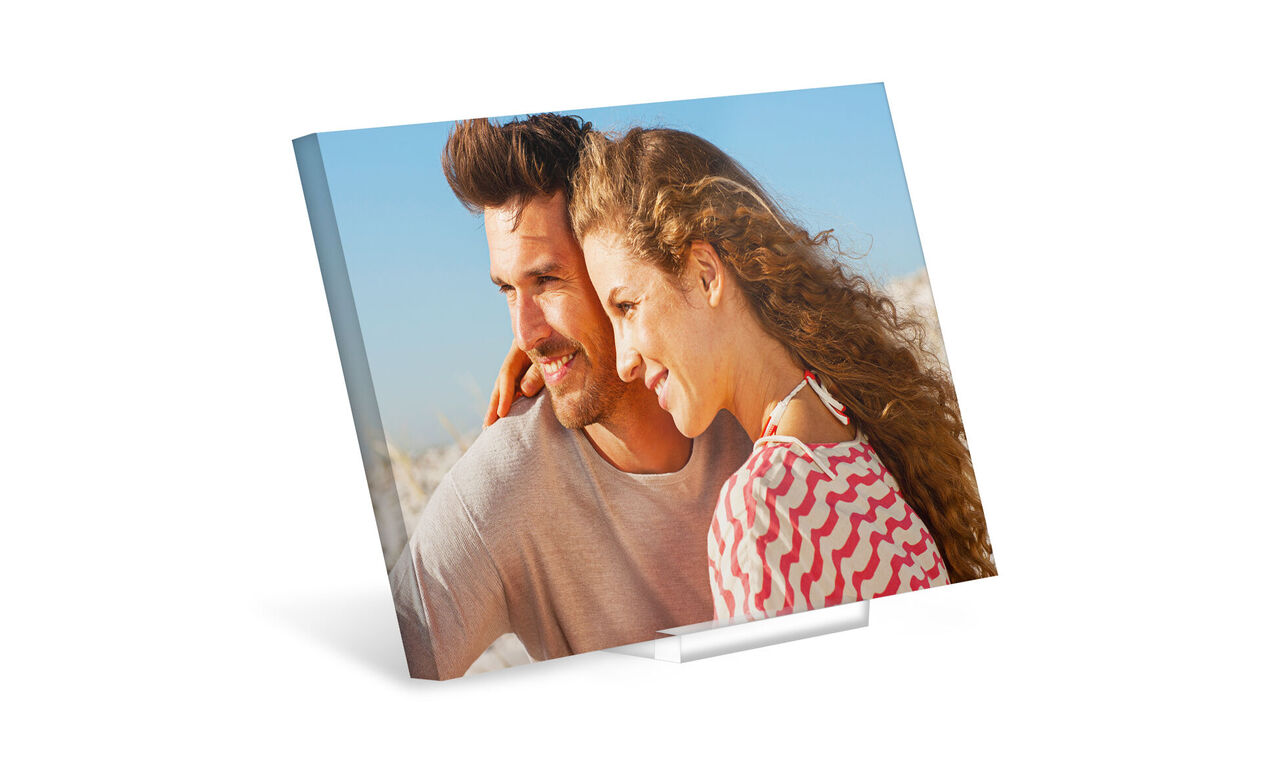 A couple enjoys a sunny day at the beach with joy and affection.