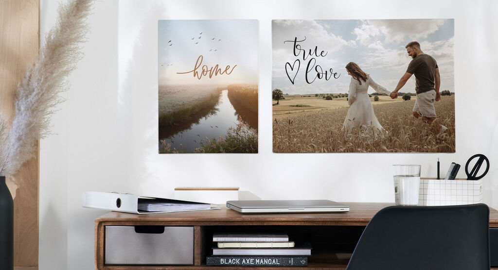 Two finished wall pictures with the inscriptions 'home' and 'true love' hang on a wall above a desk.
