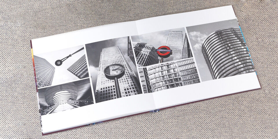 Black and white pictures of modern buildings and clocks in a photo book.