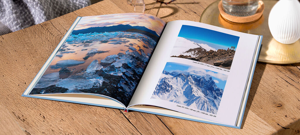 An open CEWE PHOTOBOOK with stunning images of glaciers and mountains.