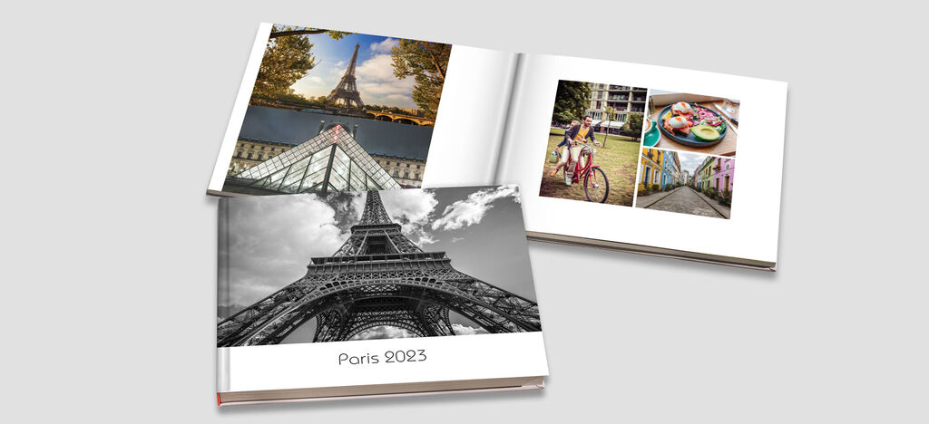 A CEWE photo book titled 'Paris 2023', showcasing photos of iconic sights and culinary experiences.