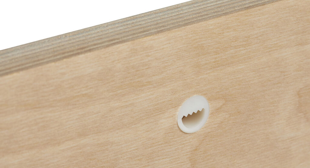 Close-up of a wall mount for a wall picture. It shows a round recess on the wood.