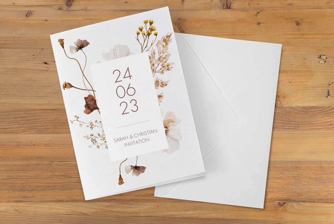 Invitation card with dried flowers, date, and names
