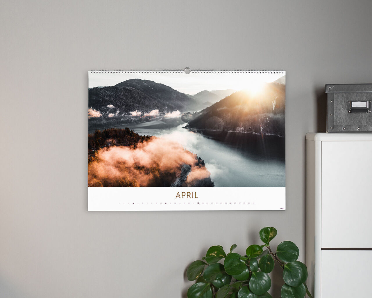 Wonderful photo calendar with a scenic image for April. It shows a sunrise over a fog-covered lake.