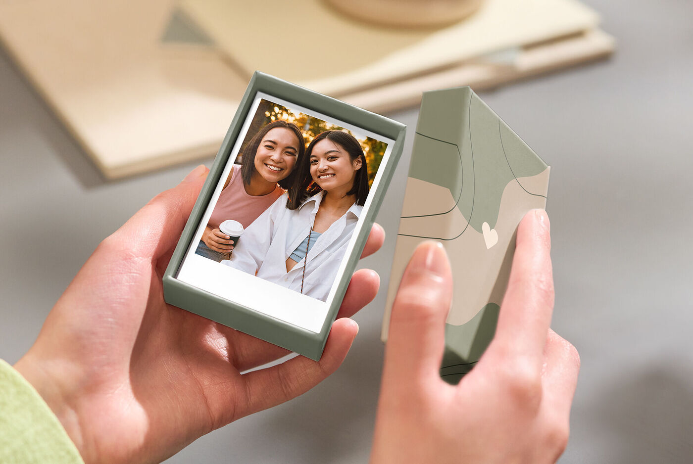 Two people hold a photo in a beautiful box and enjoy a moment of joy.