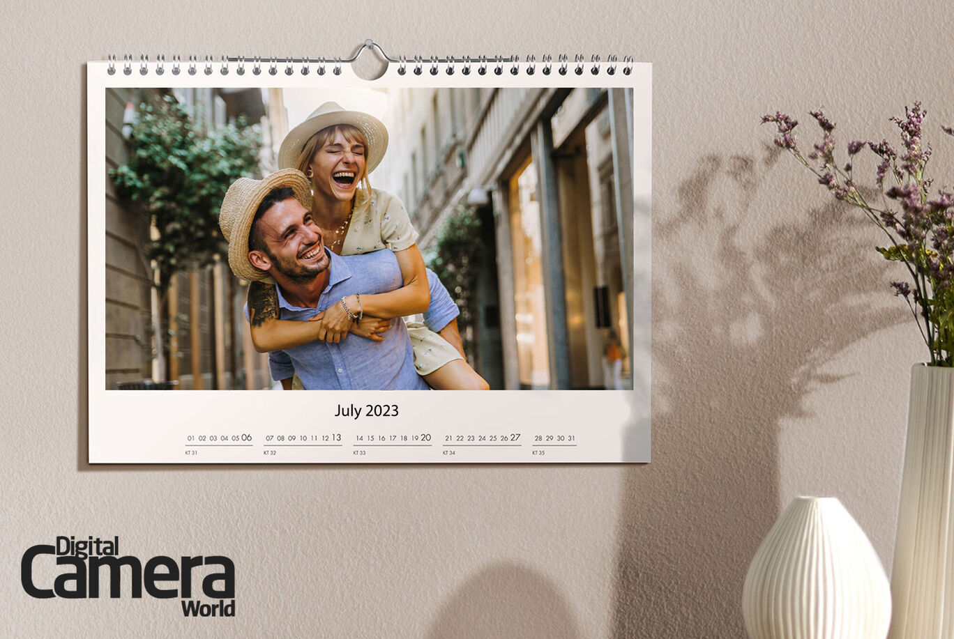A calendar page for July 2023 with a cheerful image of two people; one carries the other on their back, smiling.