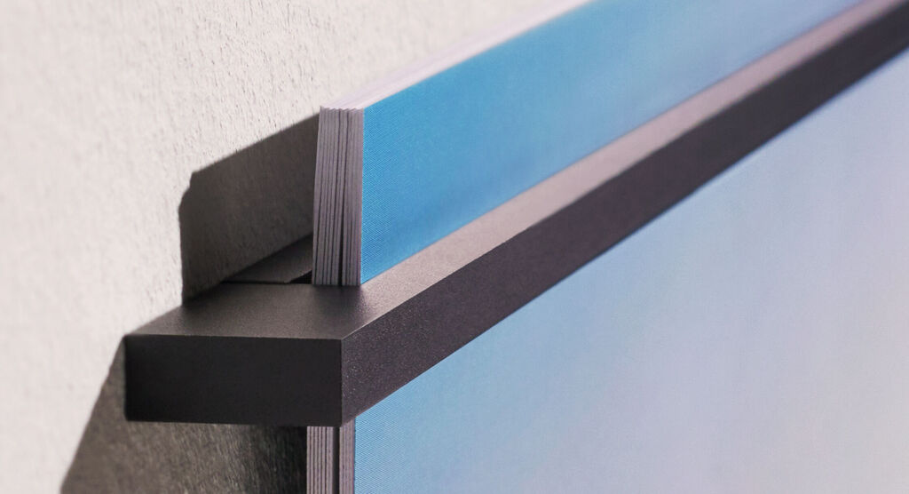 Close-up of a wall picture with a stable holder attached to the wall.