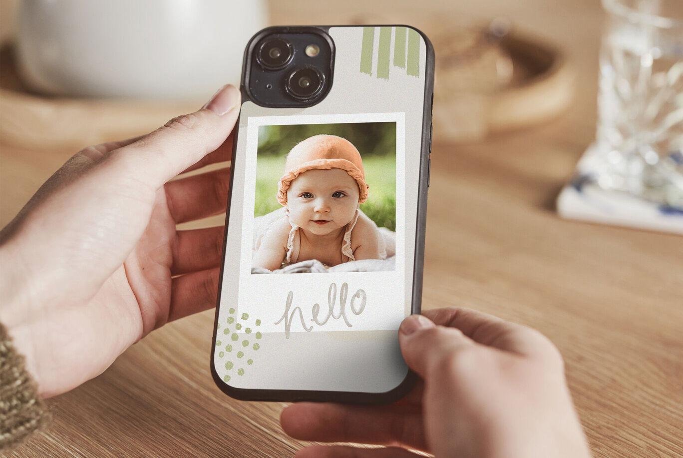 A hand holds a smartphone displaying a photo with a heartfelt "Hello".