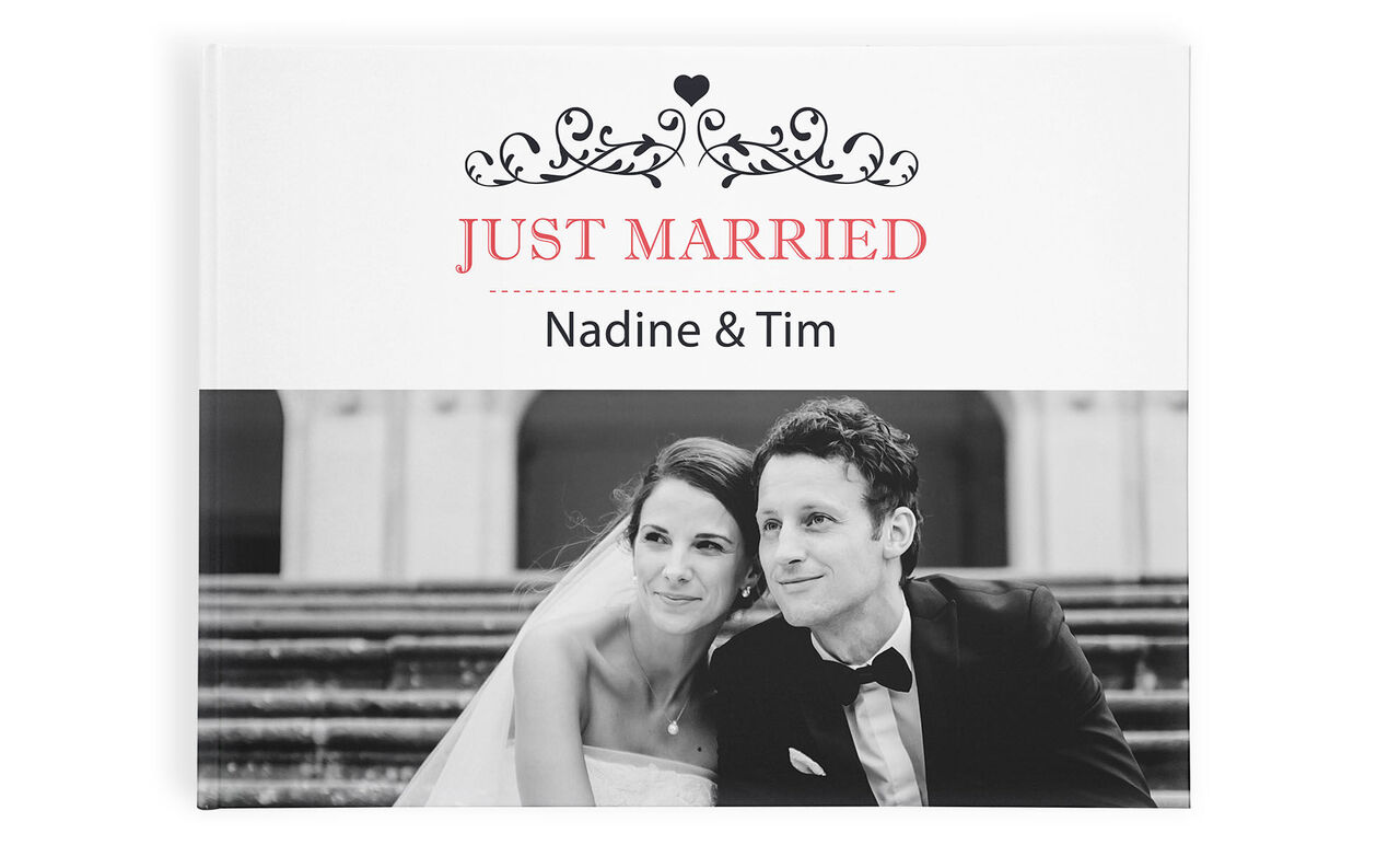 Bride and groom smile happily on the cover of a photo book.