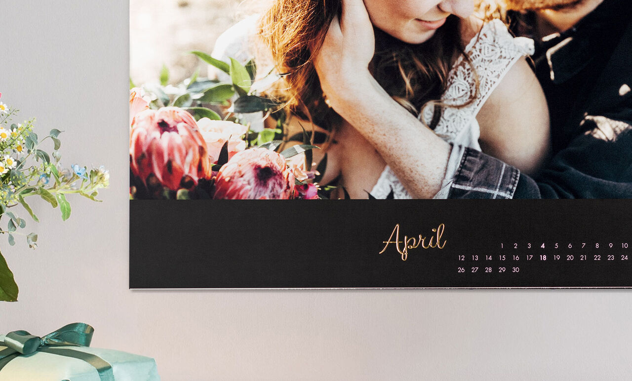 Couple in a loving embrace with blooming flowers in the background.