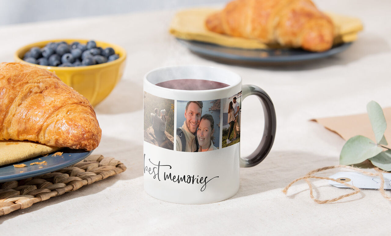 A cup with photos of memories, with croissants and blueberries beside it