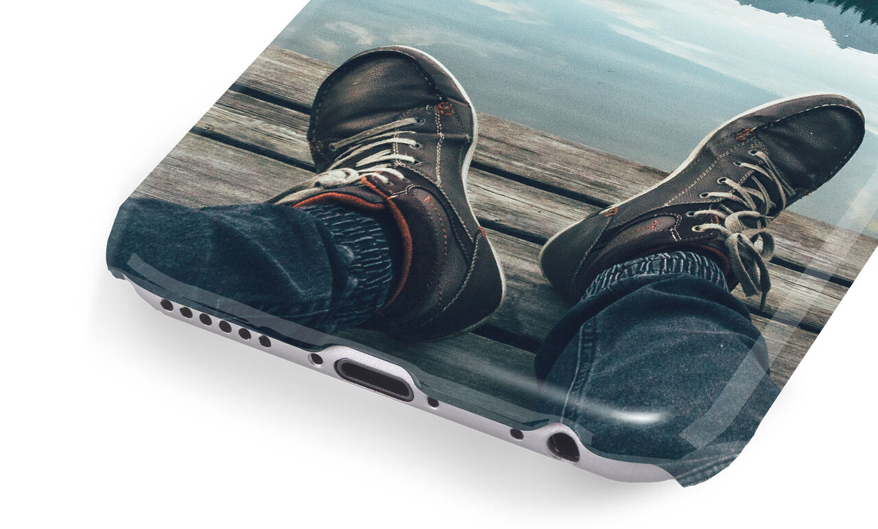 Close-up of a foot on a jetty over water, someone enjoying the calm