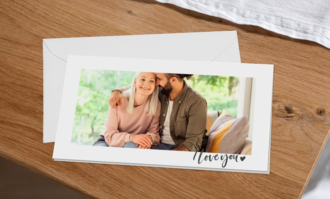 A couple sitting on a couch enjoying the moment. They share a loving gesture. The scene conveys affection and joy.
