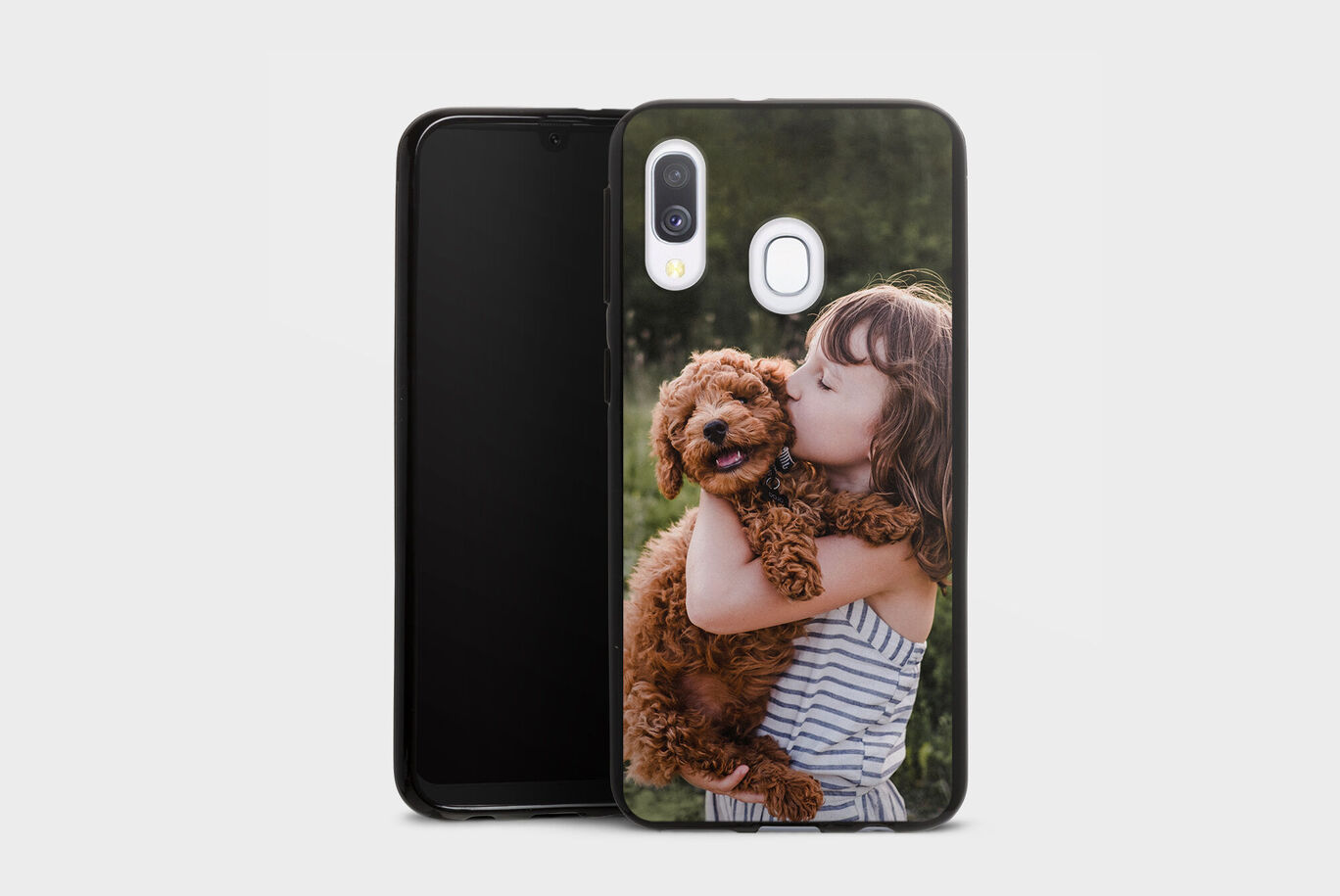 A phone case with a dog and a child on a green background.