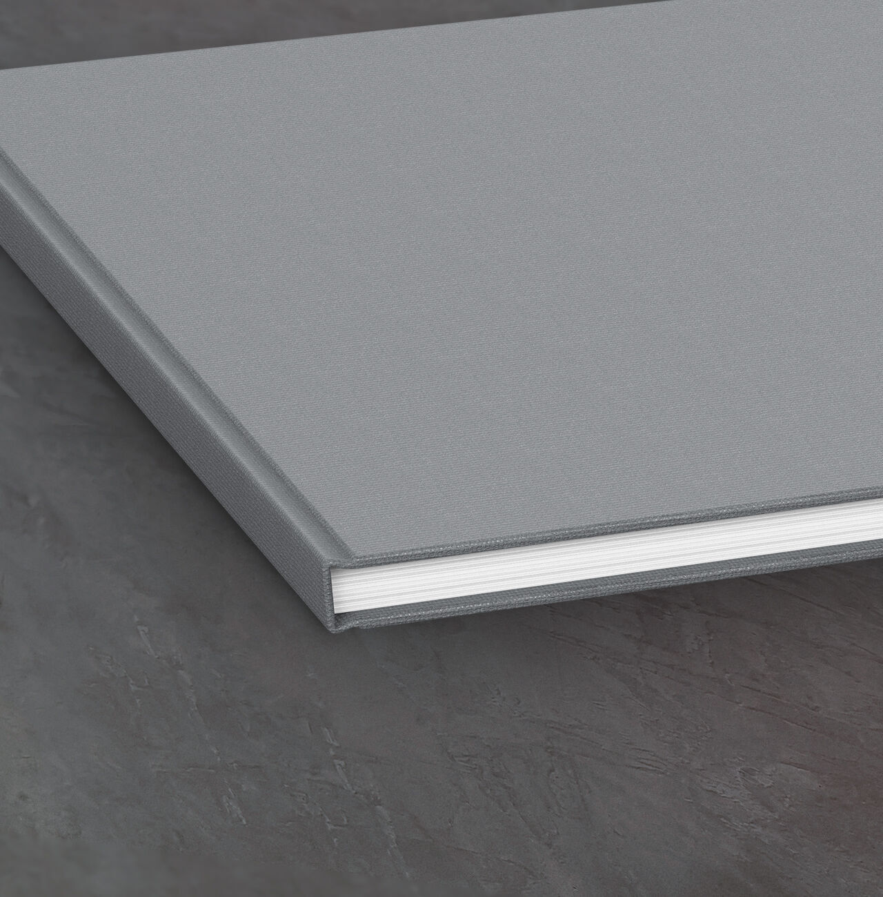 Gray CEWE PHOTO BOOK lying on a table surface.