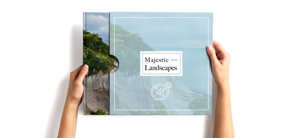 A person holds a quality CEWE photo book titled 'Majestic Landscapes'.