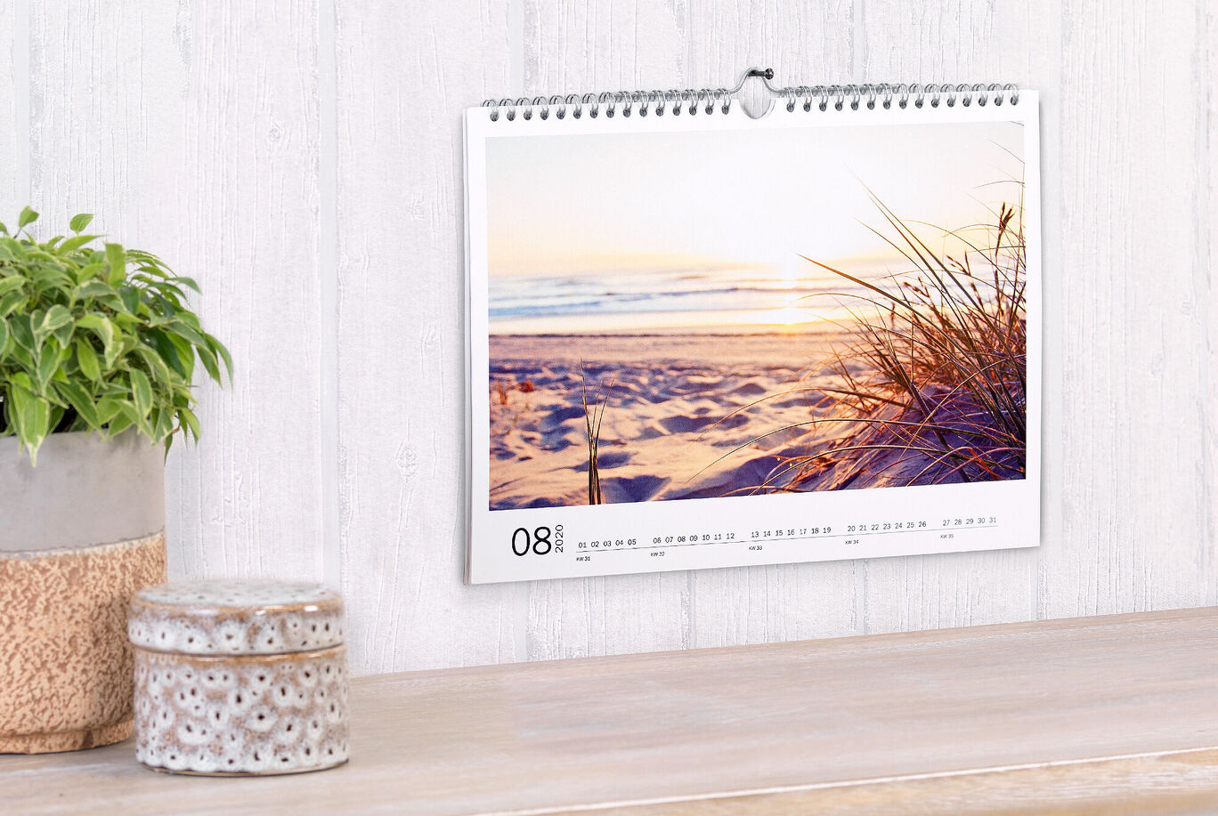 A beautiful calendar featuring a sunset at the beach and soft grasses in the foreground.