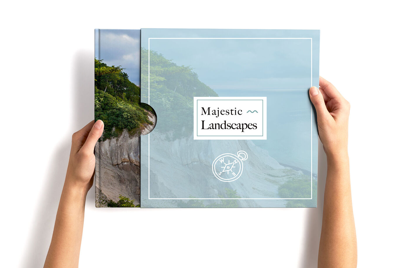 Person holding a CEWE photo book titled 'Majestic Landscapes'; the cover has a soft, light blue color.