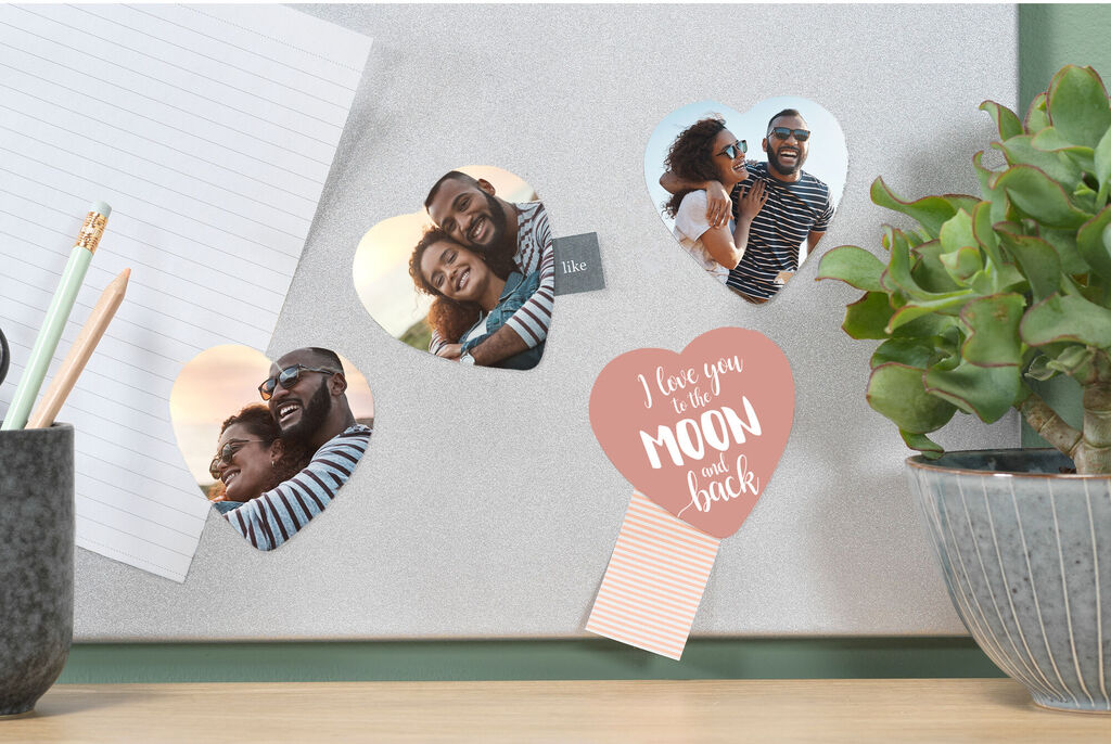 Two photos of a happy couple on a bulletin board