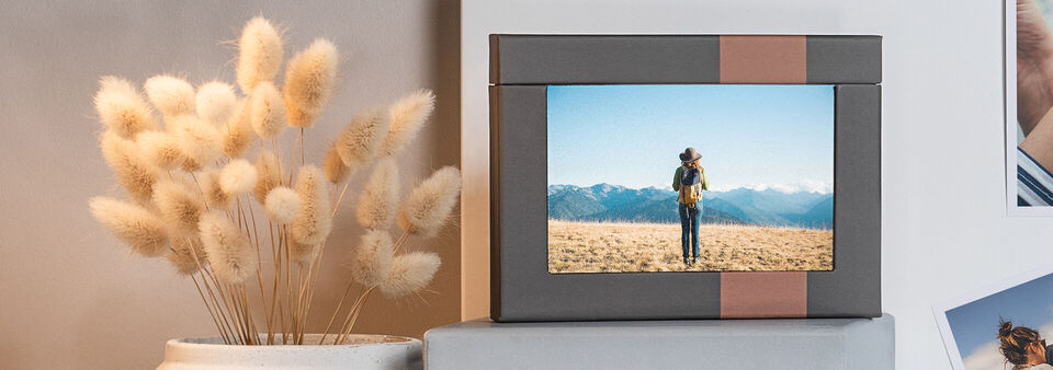 A lovingly designed photo book with an image of a person standing in nature surrounded by a beautiful flower arrangement.