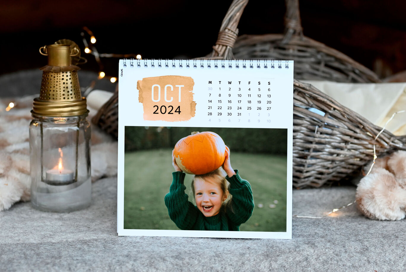 A photo calendar shows the month of October 2024 with a happy child holding a pumpkin