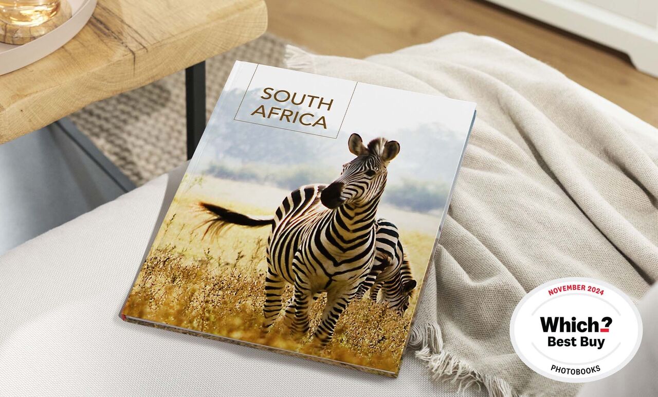 A beautiful photo book featuring a zebra on the cover, set in a savanna-like landscape. 'South Africa' is written on the cover.