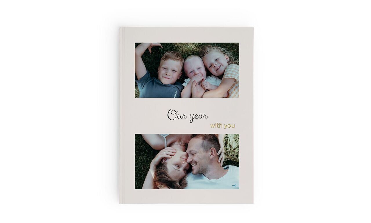 A CEWE photo book titled "Our year with you", featuring emotional pictures of a family outdoors.