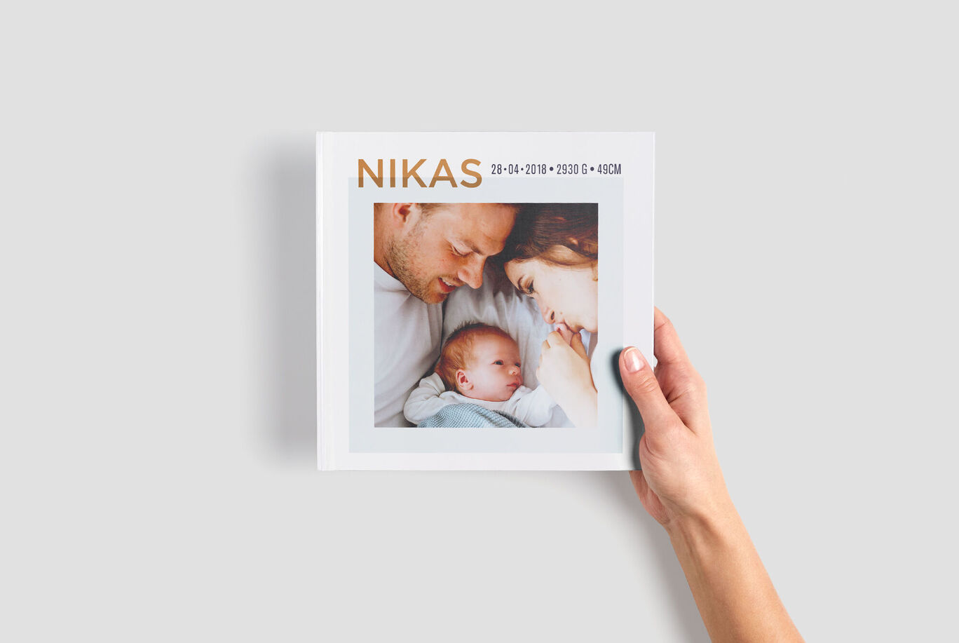 A beautiful photo book in hand showing a loving family picture.