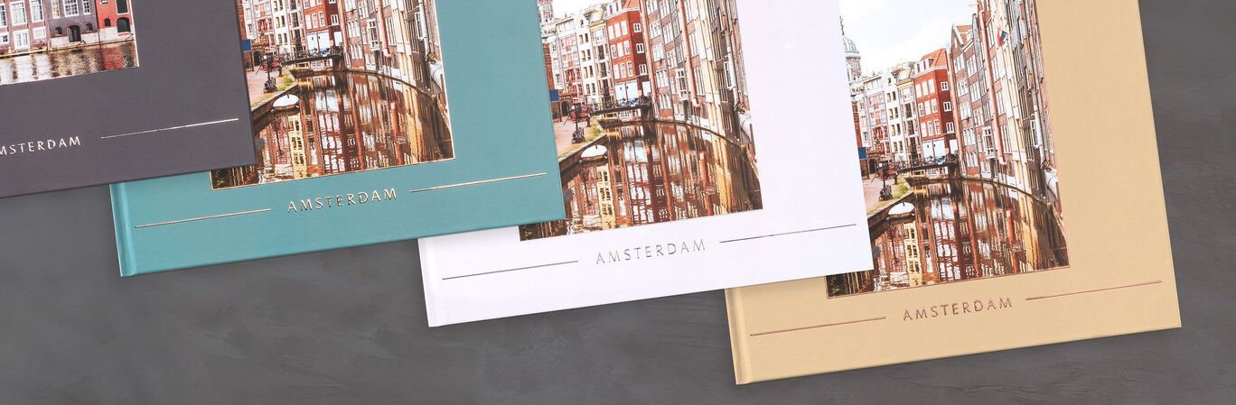Three variants of a CEWE photo book featuring a picture of Amsterdam on the cover