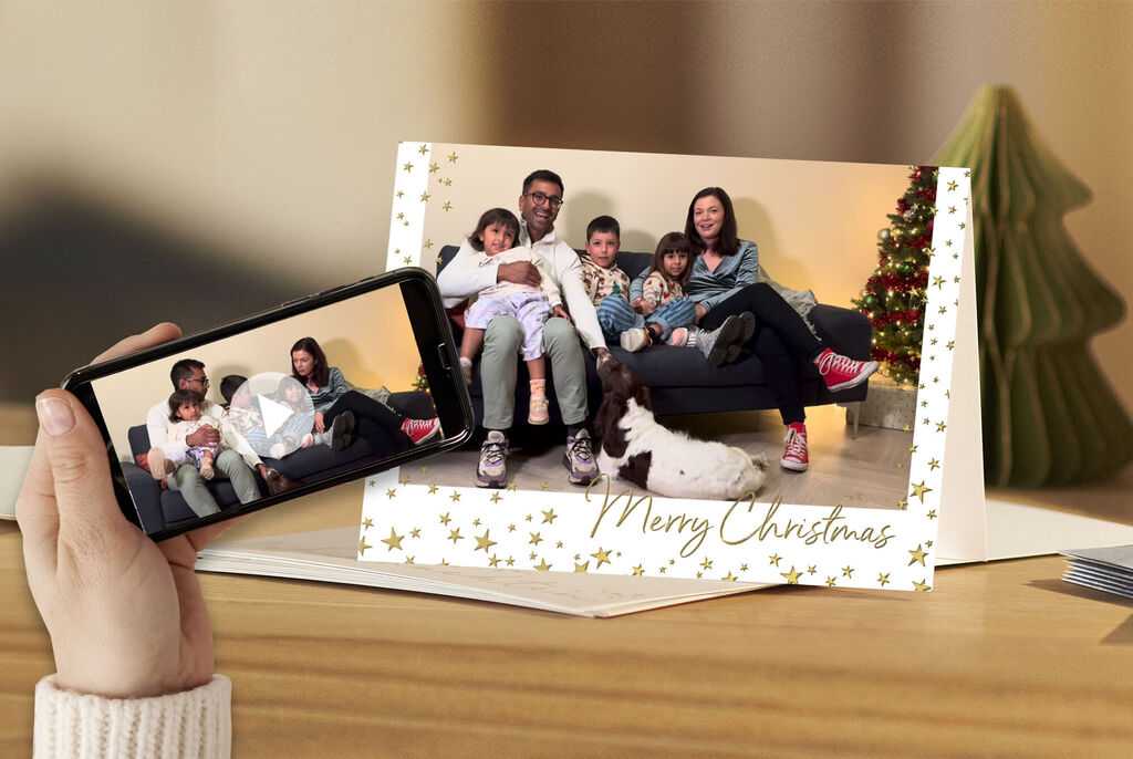 Family with several children and a dog sitting on a sofa.