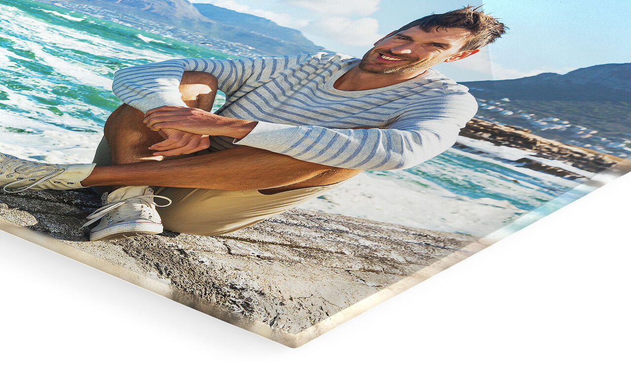 Man sits on the beach enjoying the view of the sea