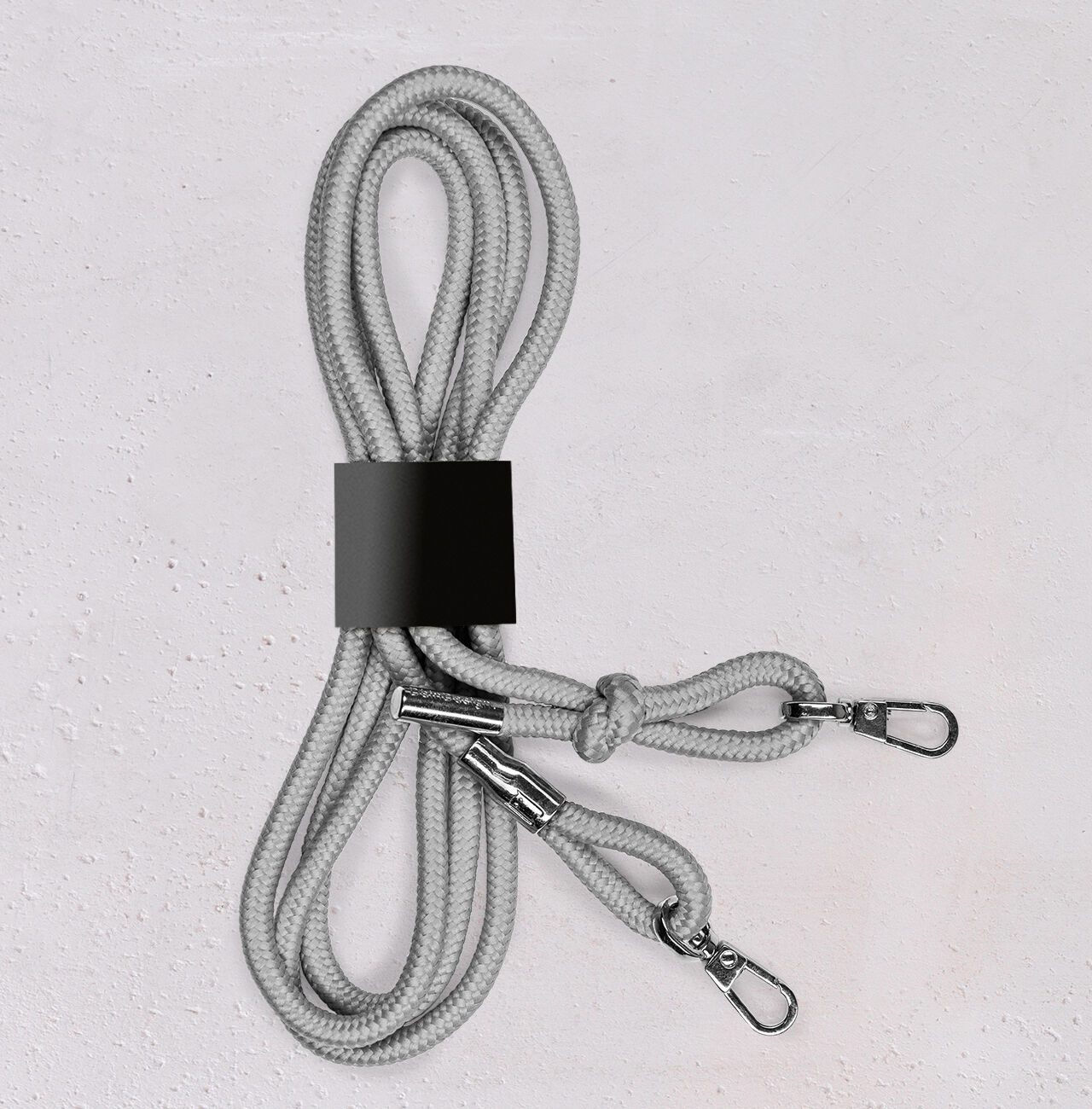 Gray rope with two carabiners, neatly coiled.