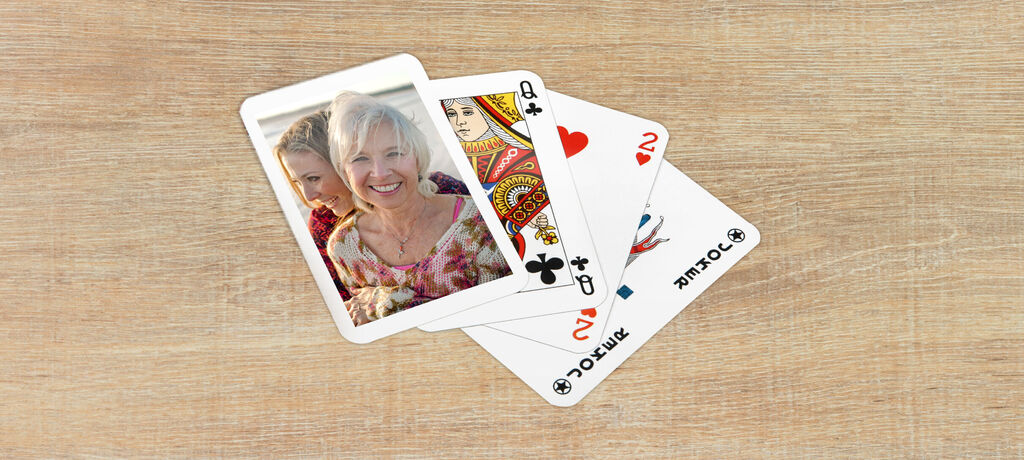 A card view with personal photos and symbols of hearts, spades, and clubs.
