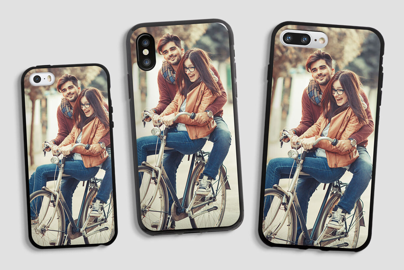 Three phones with photo cases showing a couple on bicycles outdoors