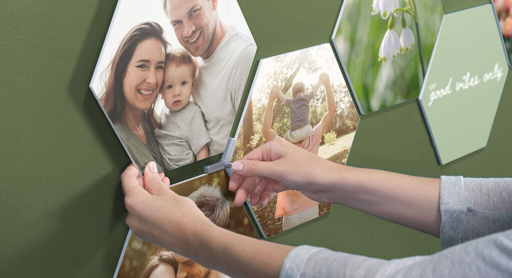 Someone is creating a creative wall with multiple pictures in hexagonal shape.