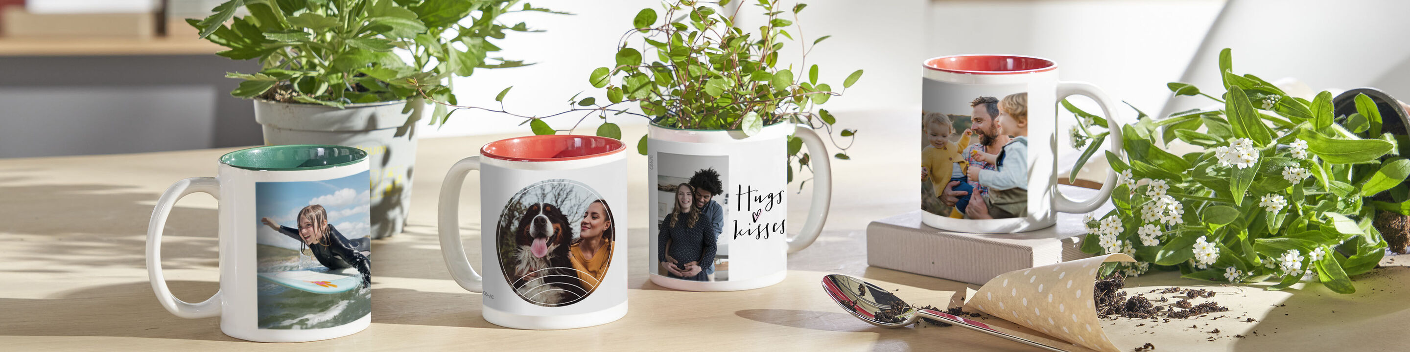 Five individually designed mugs with photos and plants on a table